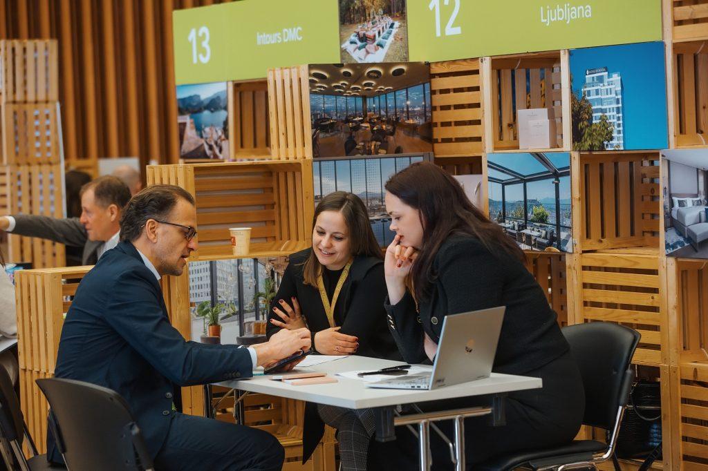 Three people having a meeting at a trade show