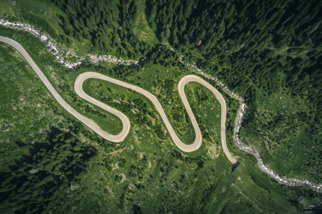 A road going through green mountains